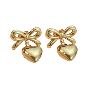 Polished 18K gold butterfly bow and heart pendant drop earrings set on white background