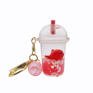 Acrylic milk tea keychain with floating red whale and pink liquid glitter charm