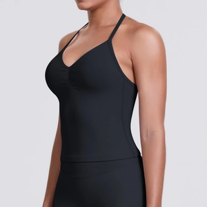 Detailed view of the seamless black sports top showing ribbed hem and V-neckline texture