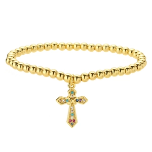 Gold beaded heart and cross bracelet with colorful gemstones on a clean white background