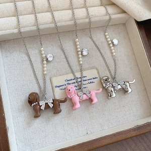 Three dachshund necklaces in brown, pink, and silver with pearl beads and bow charms
