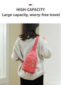 Detail showing red nylon chest bag with three zipper compartments and pink beaded pulls