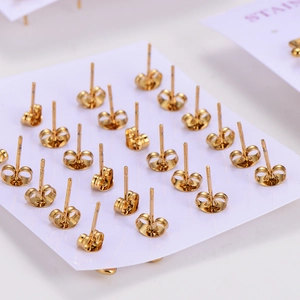 Golden stainless steel earring set with musical note and floral studs on a white card