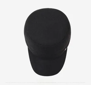 Top down view of black knit patrol cap with textured honeycomb fabric and metal side logo