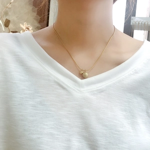 Golden titanium steel snake chain necklace with smooth and frosted sphere pendants