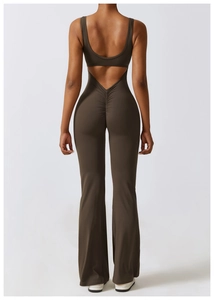 Detail of deep V-back cutout and gathered scrunch seam on brown flared yoga jumpsuit