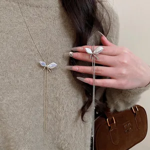Elegant Y-shaped pearl butterfly pendant necklace with pavé diamonds and tassels