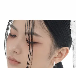 Close-up of S925 sterling silver earring with unique wrinkled texture on a female model