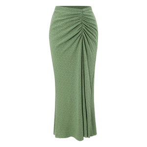 Detailed close-up of sage green maxi skirt featuring ruched waist and textured fabric
