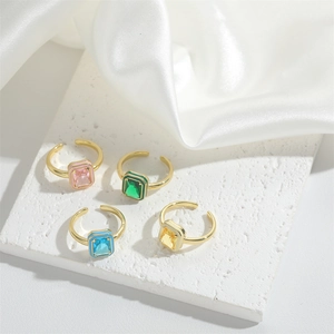 Adjustable gold rings with square colorful zircon stones and enamel frames on marble