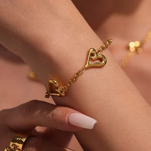 Set di gioielli cuore in acciaio inossidabile dorato lucido indossato da una modella