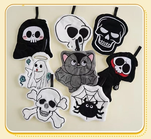 Detail of coral fleece Halloween hand towels featuring cartoon skull and bat designs