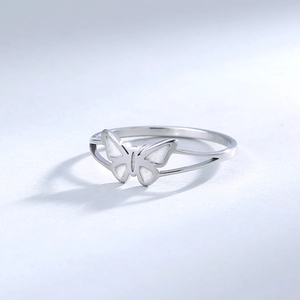 Detail showing butterfly motif with white inlay on polished 304 stainless steel ring