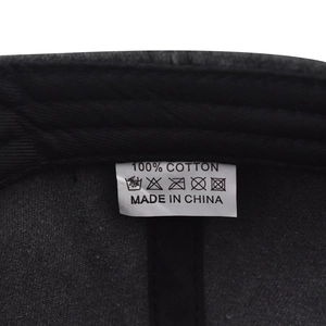 Detail view of the 100% cotton material tag inside the washed charcoal baseball cap