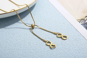 Detail of adjustable gold infinity lariat necklace with square snake chain and sliding clasp