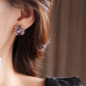 Macro view of square purple gemstone earrings with micro-pave diamonds on model