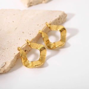 Detail of 18K gold plated stainless steel earrings with irregular geometric ripple texture