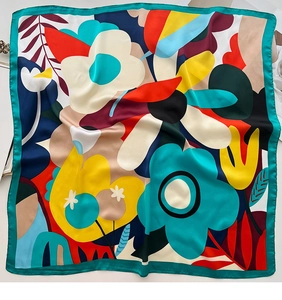 Detail of square silk scarf with abstract floral print and green rolled edges