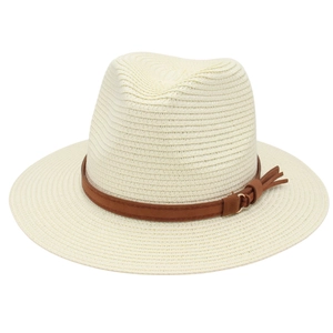 Detail of woven straw fedora hat featuring a brown leather band and gold metal ring