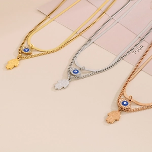 Detailed comparison of Hamsa Hand and Evil Eye pendants in gold, silver, and rose gold