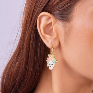 Close-up of Halloween skull earring with colorful flowers worn on a female ear