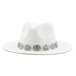 Detailed view of the bohemian silver metal sunburst band on a white woven Panama hat