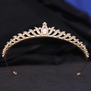 Close-up of golden bridal tiara with sparkling pear-shaped zircon and rhinestones