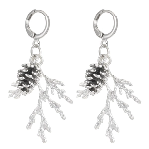Detailed close-up of vintage silver pine cone and branch earrings with metallic luster