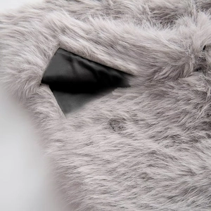 Close-up of fluffy grey faux fur texture with smooth black glossy lining detail