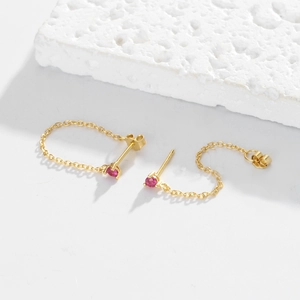 Detailed close-up of gold S925 sterling silver chain earrings with red zircon gemstones