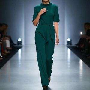 Dark green short sleeve wide leg jumpsuit with belted waist and lapel collar