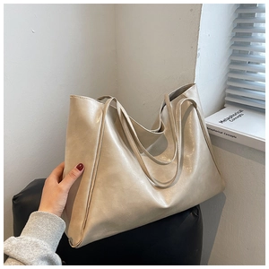 Minimalist cream white tote bag in soft PU leather shown in a stylish lifestyle setting