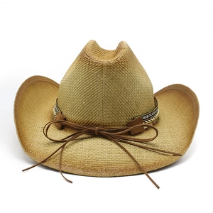 Detail of hand-woven straw cowboy hat with ethnic geometric band and brown leather cord
