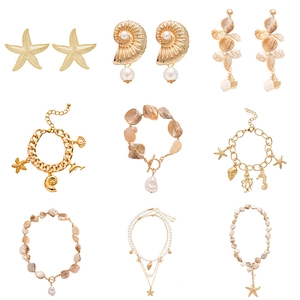 Gold ocean themed jewelry set with starfish shells and pearls in a minimalist grid layout