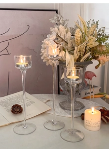 Three-piece set of graduated glass candle holders for a romantic dinner table setting