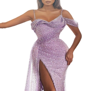 Detailed view of dark purple sequin gown with high slit and elegant spaghetti straps