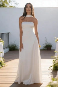 Detail of elegant white strapless evening dress with silky satin finish and floor-length hem