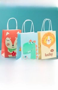 Three cartoon gift bags with animal prints like foxes and lions and rope handles