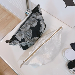 Floral jacquard cosmetic bags with metal zippers in elegant black and white colors