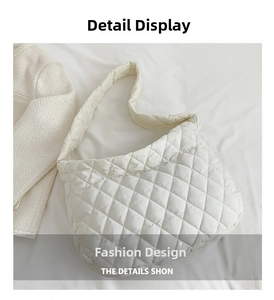 Detailed view of white quilted puffer shoulder bag with a soft diamond lattice pattern