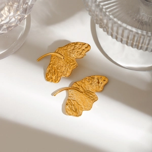 Close-up of golden hammered ginkgo leaf earrings made of high-quality titanium steel