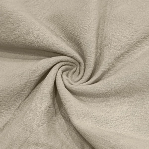 Macro shot of breathable beige linen blend fabric with waffle texture and subtle wrinkles