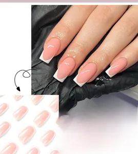 Detailed view of pink and white French press-on nails with glossy finish on hand