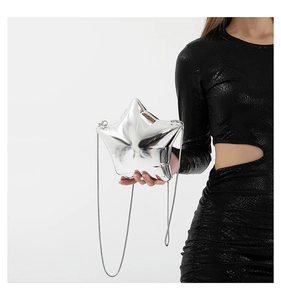 Detail of silver star-shaped acrylic mini bag with sleek metallic chain strap