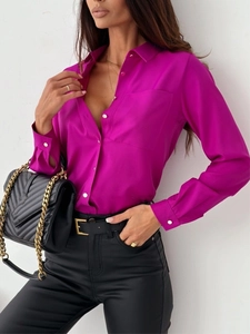Detail of fuchsia long sleeve blouse with lapel collar and single chest pocket