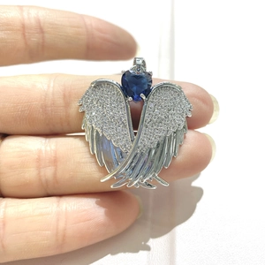 Silver angel wing pendant with heart-shaped blue gemstone and micro-paved zircons