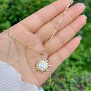 18k gold plated sunburst necklace with mother of pearl pendant and zircons in natural light