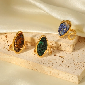 Close-up of gold adjustable rings with tiger eye, malachite and lapis lazuli stones