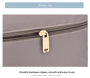 Detail of durable nylon fabric with premium gold metal zipper and smooth logo slider