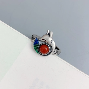 Macro view of silver fox ring with red gemstone and colorful enamel details